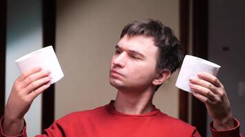 Man choosing between two toilet paper rolls in bathroom video