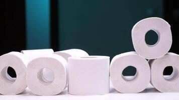 Hand taking toilet paper roll from a large pile video