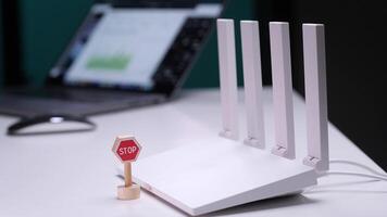 Hand placing stop sign in front of wireless router symbolizing internet security video