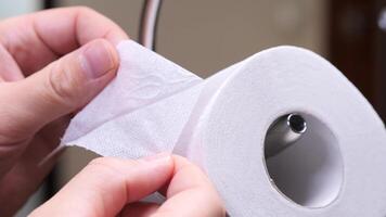 close up of two layers of toilet paper. separation of two-ply toilet paper into layers. video