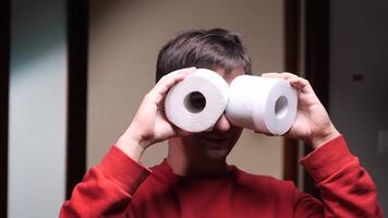 Man using toilet paper rolls as binoculars. having fun at home video