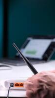 vertical Technician adjusting antenna of wi-fi router for improving internet signal video