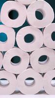 vertical Stack of toilet paper rolls forming a pyramid on a white surface video