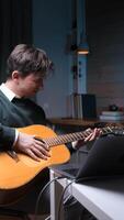 vertical A man learns to play the guitar and gets angry. Online guitar lessons. video