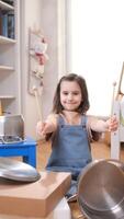 vertical portrait Little girl playing drums with kitchen utensils in bedroom video