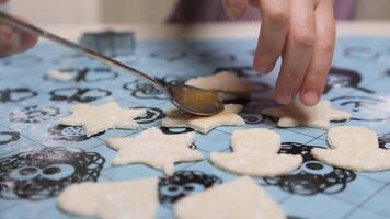 close-up little girl Child preparing cookies with apricot jam on a baking mat video