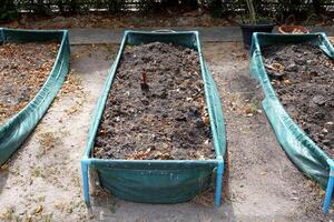 Vegetable plot and small spade in green frame on ground in Thailand. photo