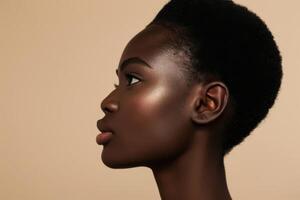 female's face with radiant, glowing skin against a plain beige background photo