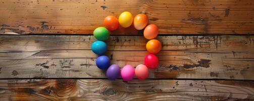 colored Easter eggs in a circle on a wooden surface photo