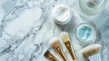 flat lay of beauty products including face masks, brushes, and serums on a marble surface photo