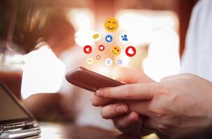 Men use smartphones to interact with social media. following news, communicating with others through emojis and online messages, notifications, opinions photo