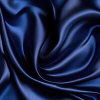 Luxurious deep navy silk fabric showing elegant folds and textures under soft light photo