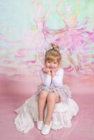 Cute Ballerina Doing Exercises Set in the studio photo