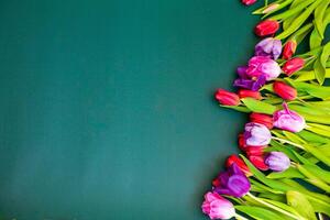 Bouquet color tulips on green background. Flat lay, top view, copy space photo