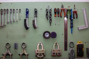 A wall with various tools hanging on it photo