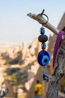A blue evil eye on a tree branch photo