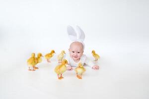 kid in a bunny costume with ducklings , enjoying, cute kid and animal friend photo