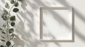 Minimalistic mockup of a photo frame with an eucalyptus branch on a white wall. 3D rendering