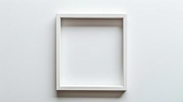 White picture frame on white wall. Empty space for your design. photo