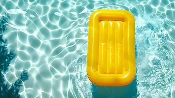 Yellow air mattress floating in the pool. top view photo