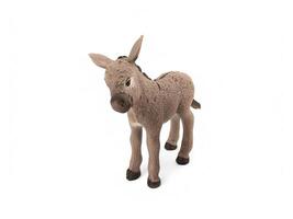 A toy donkey standing on a white background photo