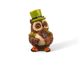 An owl figurine wearing a green hat photo
