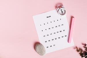 Calendar, alarm clock and marker on pink background top view web banner photo