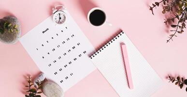Monthly calendar and blank planning notebook on the desktop top view web banner photo