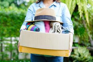 Volunteer collect cloth and hat in cardboard box photo