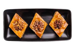 Homemade Walnut Baklava with honey on plate isolated on white background. top view photo