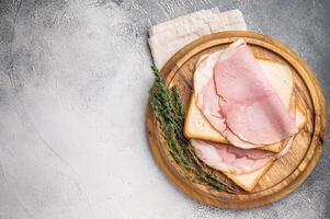 Ham sandwich, Bread with sliced pork meat. grey background. top view photo