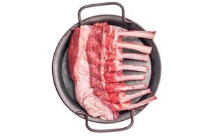Fresh rack of lamb, raw mutton meat for chops steaks on steel tray isolated on white background. top view photo