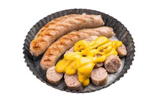 Grilled Bratwurst Sausages with cheese sauce in plate isolated on white background. top view photo