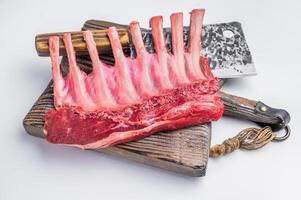 Butcher board with Raw lamb meat for chops steaks, fresh rack of mutton isolated on white background. top view photo