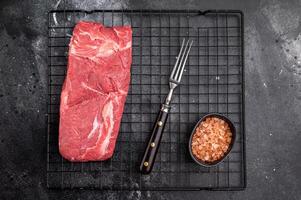 Close-up of raw horse meat, emphasizing its quality and freshness, ready to be transformed into exquisite dishes for adventurous palates. black background. top view photo