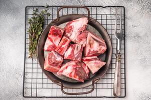 Raw Beef meat and veal bones for stew or goulash. grey background. top view photo