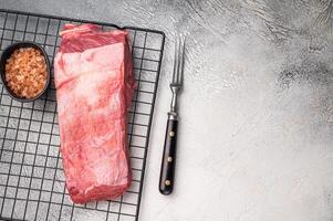 Close-up of raw buffalo meat cuts, highlighting the marbling and vibrant hue, perfect for creating delicious and nutritious dishes. grey background. top view photo