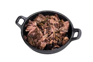 Slow cooked Shredded beef ragu in a skillet isolated on a white background. top view photo