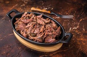 Slow Cooked Pulled Beef, Traditional meat rubbed with spices and smoked. brown background. top view photo