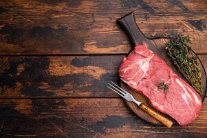 Vibrant raw horse meat on a rustic wooden surface, highlighting its rich color and fine marbling, ideal for unique culinary dishes. wooden background. top view photo