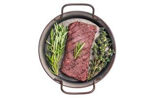 Grilled Flank or Flap steak, BBQ beef meat with thyme and spices on plate isolated on white background. top view photo
