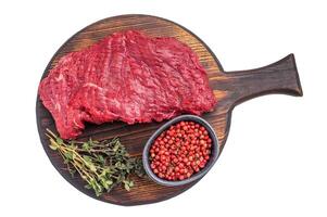 Flank or Flap steak, raw beef meat with thyme on wooden board isolated on white background. top view photo