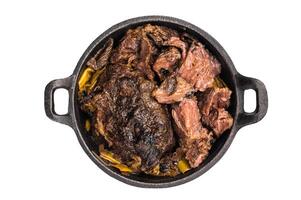Red Wine Braised Beef Cheek meat with Creamy sauce in a skillet isolated on white background. top view photo