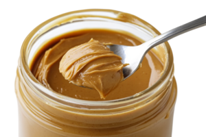 Spoonful of creamy peanut butter in a jar png