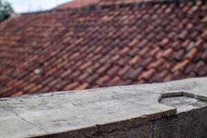 Blurred Roof Tiles with Concrete Surface Texture in Focus photo