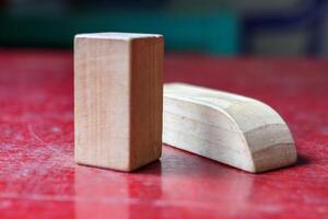Minimalist Wooden Blocks on a Rustic Red Surface photo