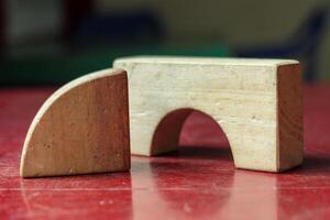 Wooden Geometric Blocks on Red Table, Abstract Educational Shapes photo