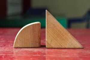 Wooden Geometric Blocks on Red Surface , Abstract Shapes photo