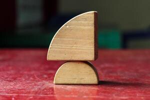Balanced Wooden Blocks on a Red Table , Abstract and Minimalist Composition photo