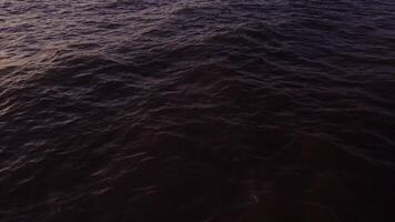 Drone flies over dark sea water. Small waves, top view. Quadcopter , no land, only water. video